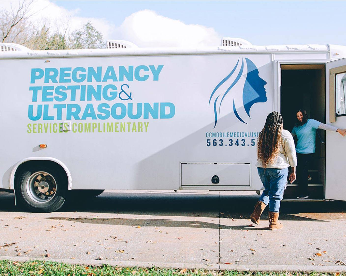 Woman walking onto a Mobile Medical Clinic