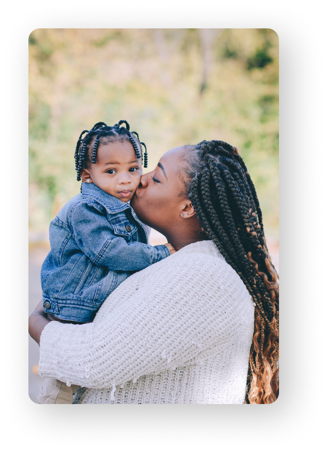 mom kissing child in her arms