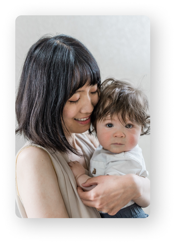 Mom holding child and smiling